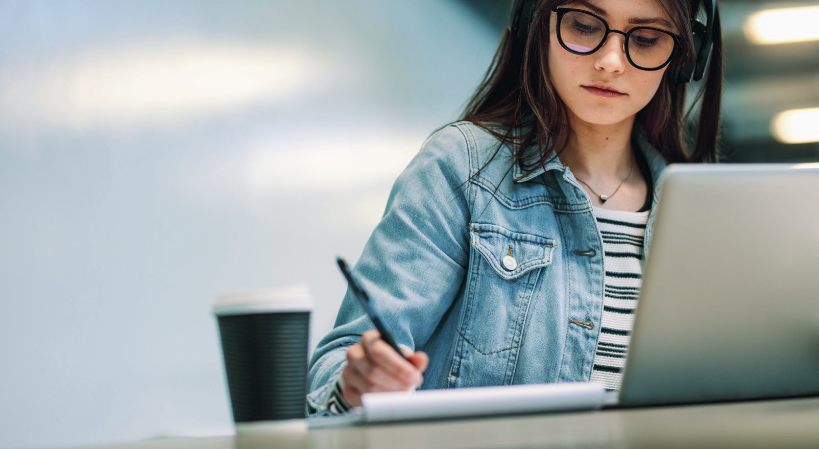 Decorative image showing a female student at work