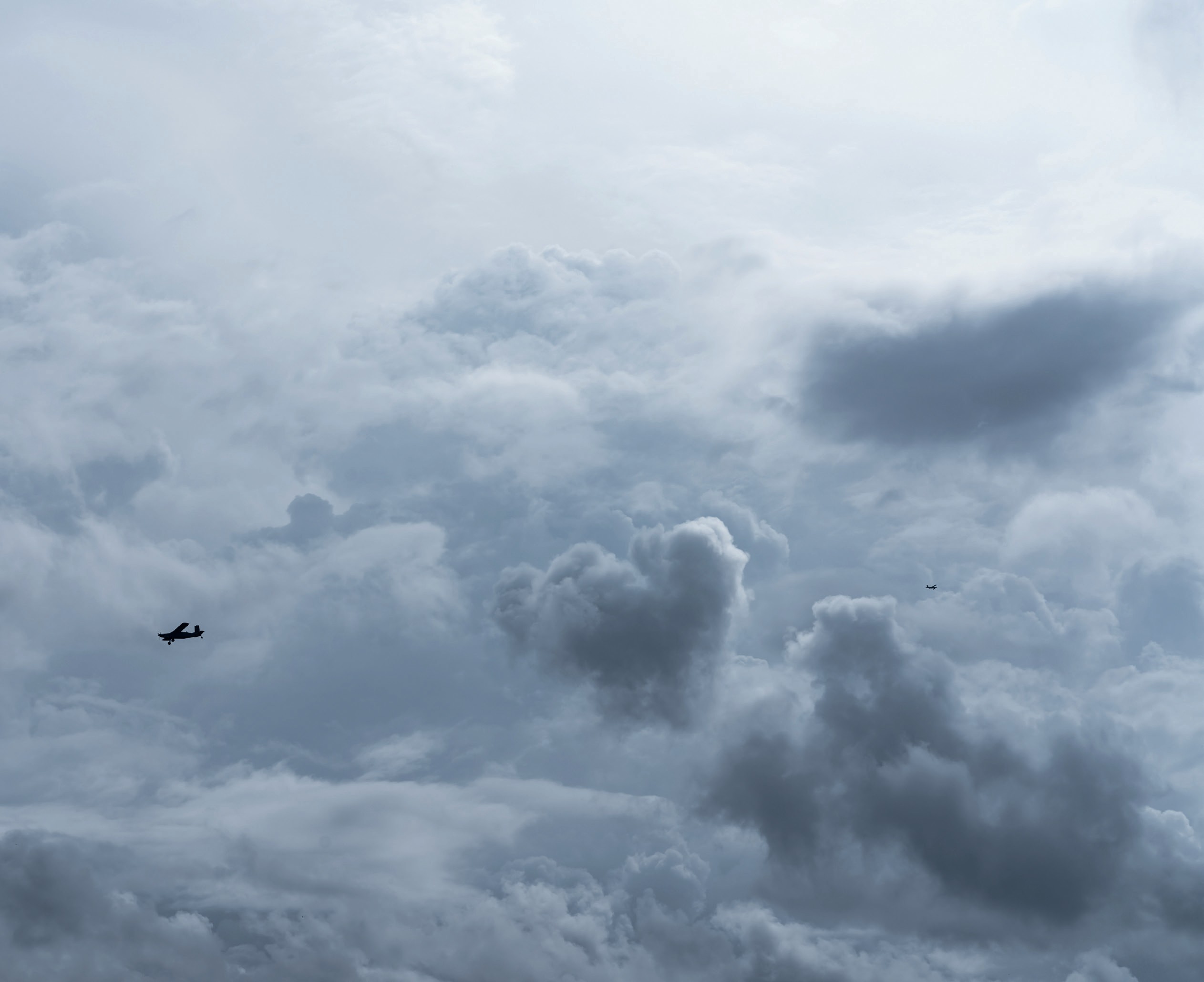 An aeroplane flies through clouds.