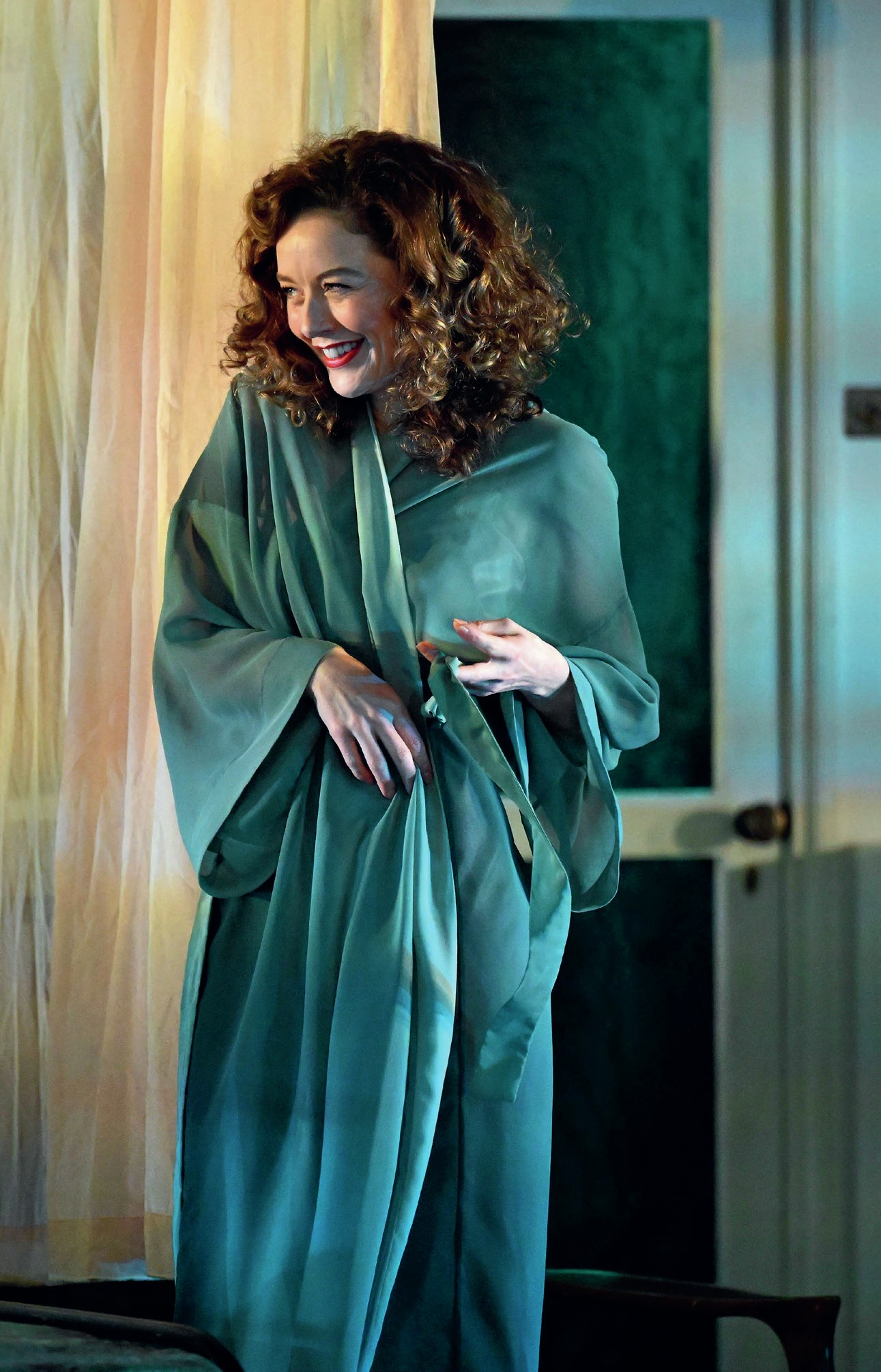 Blanche on stage, by herself, wearing a dressing gown and smiling.