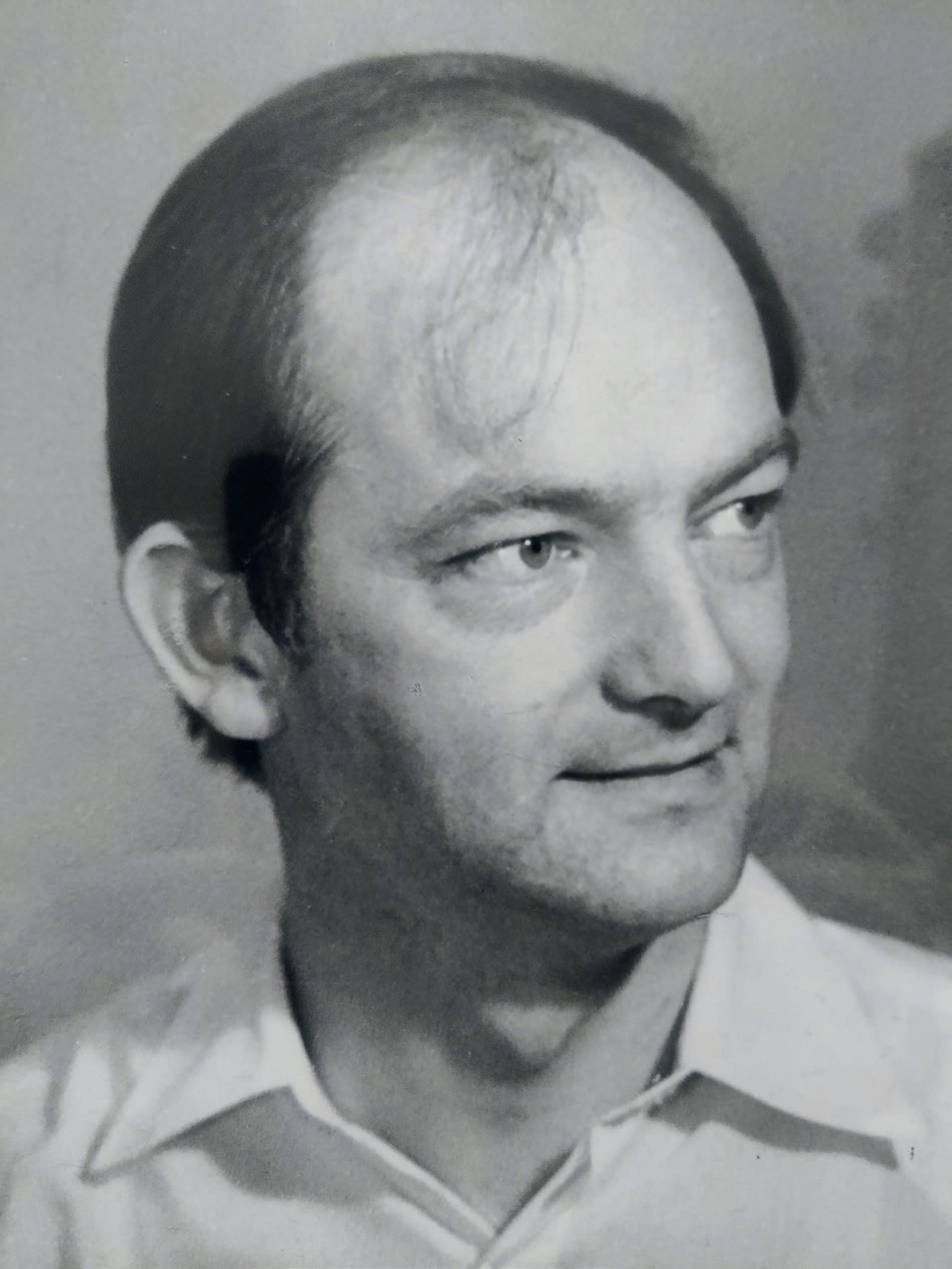 A black-and white headshot of a man.