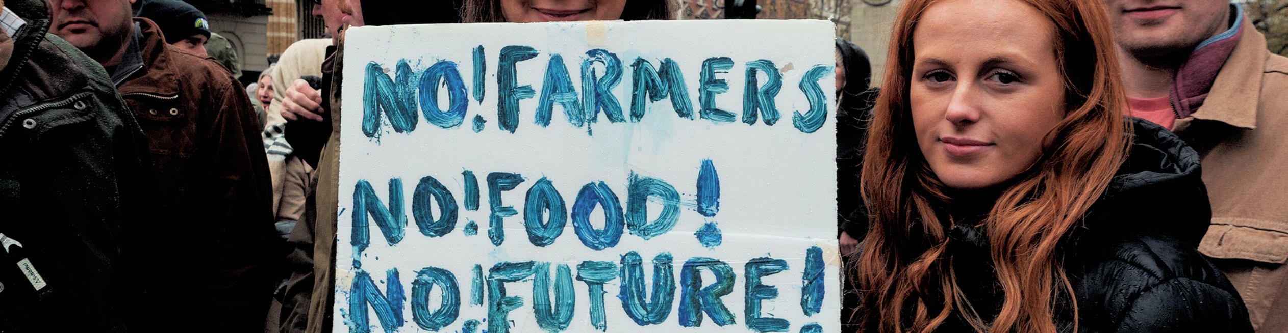 Protestor with a sign that reads ‘No! Farmers. No! Food! No! Future!’