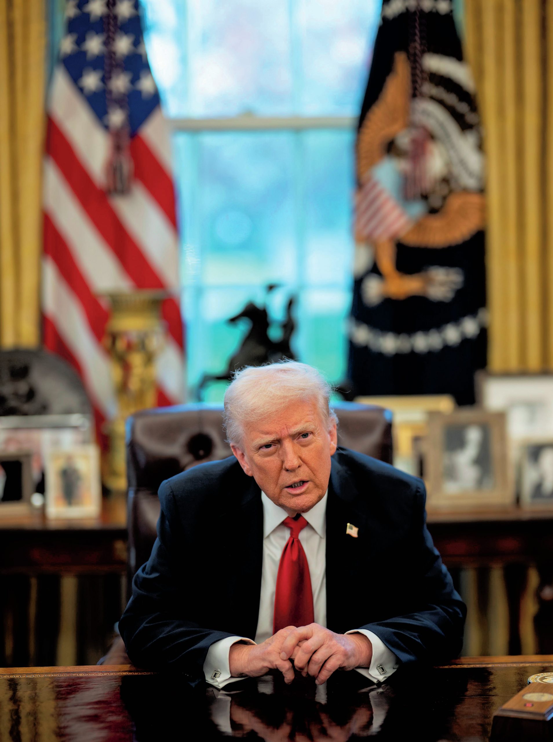 Trump sitting at his desk in the White House.