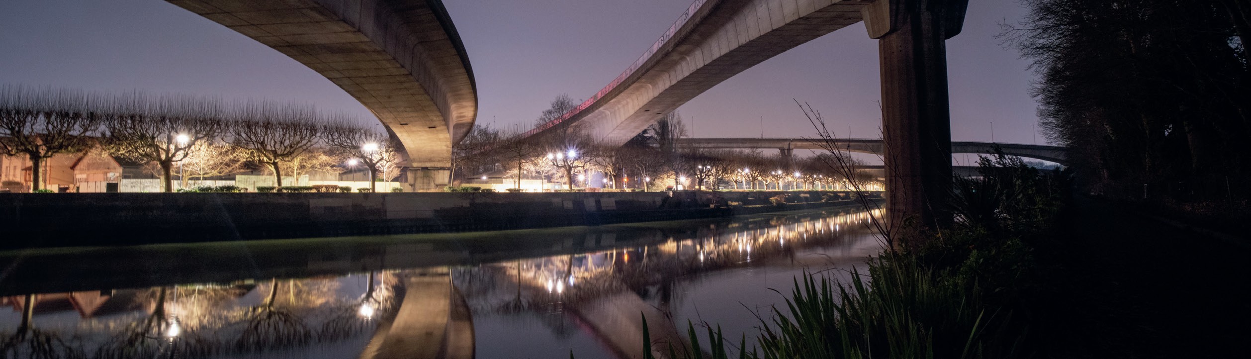 Nighttime view of motorway bridges.