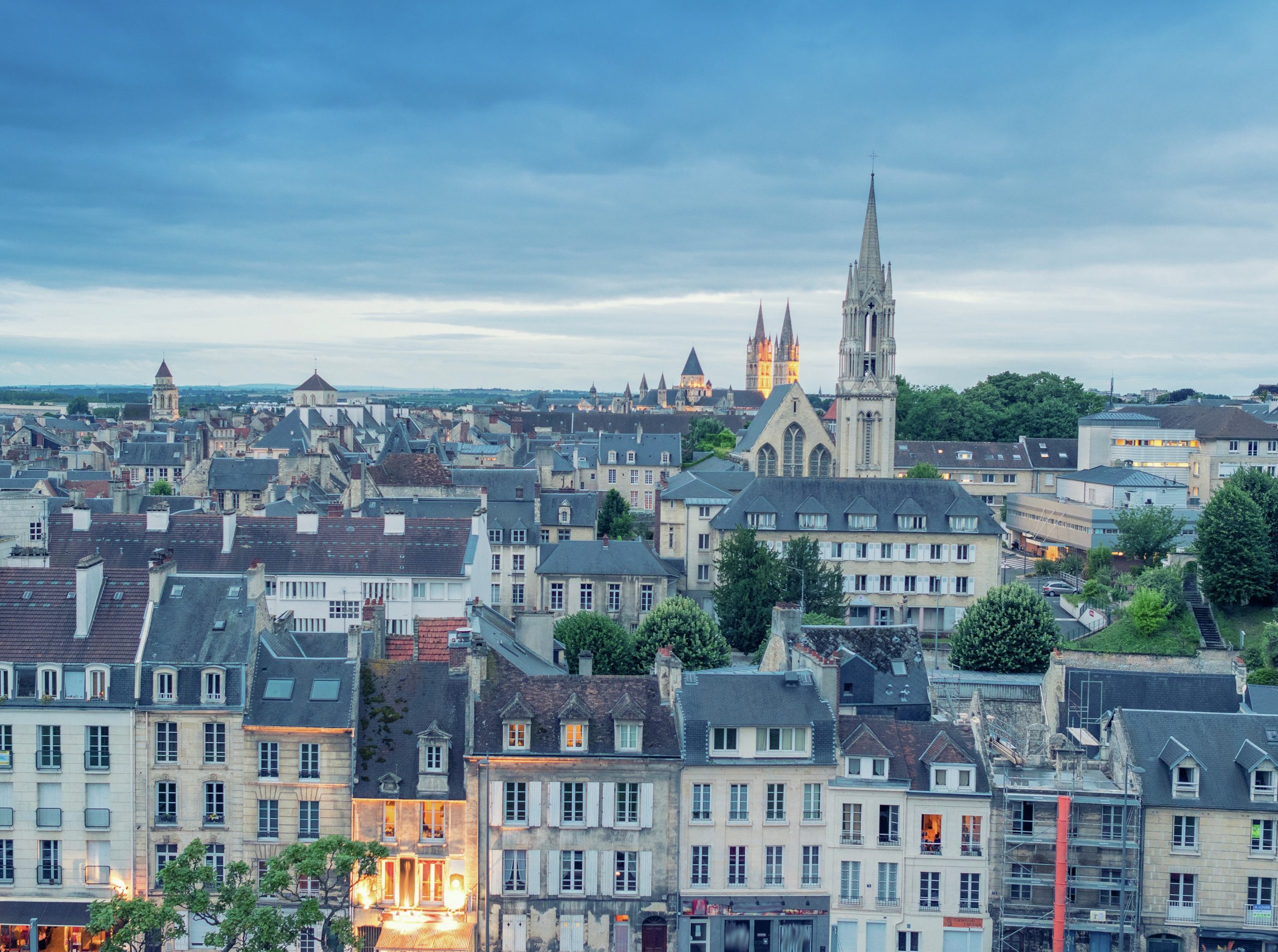 View of Caen rooftops, with a church in the background.