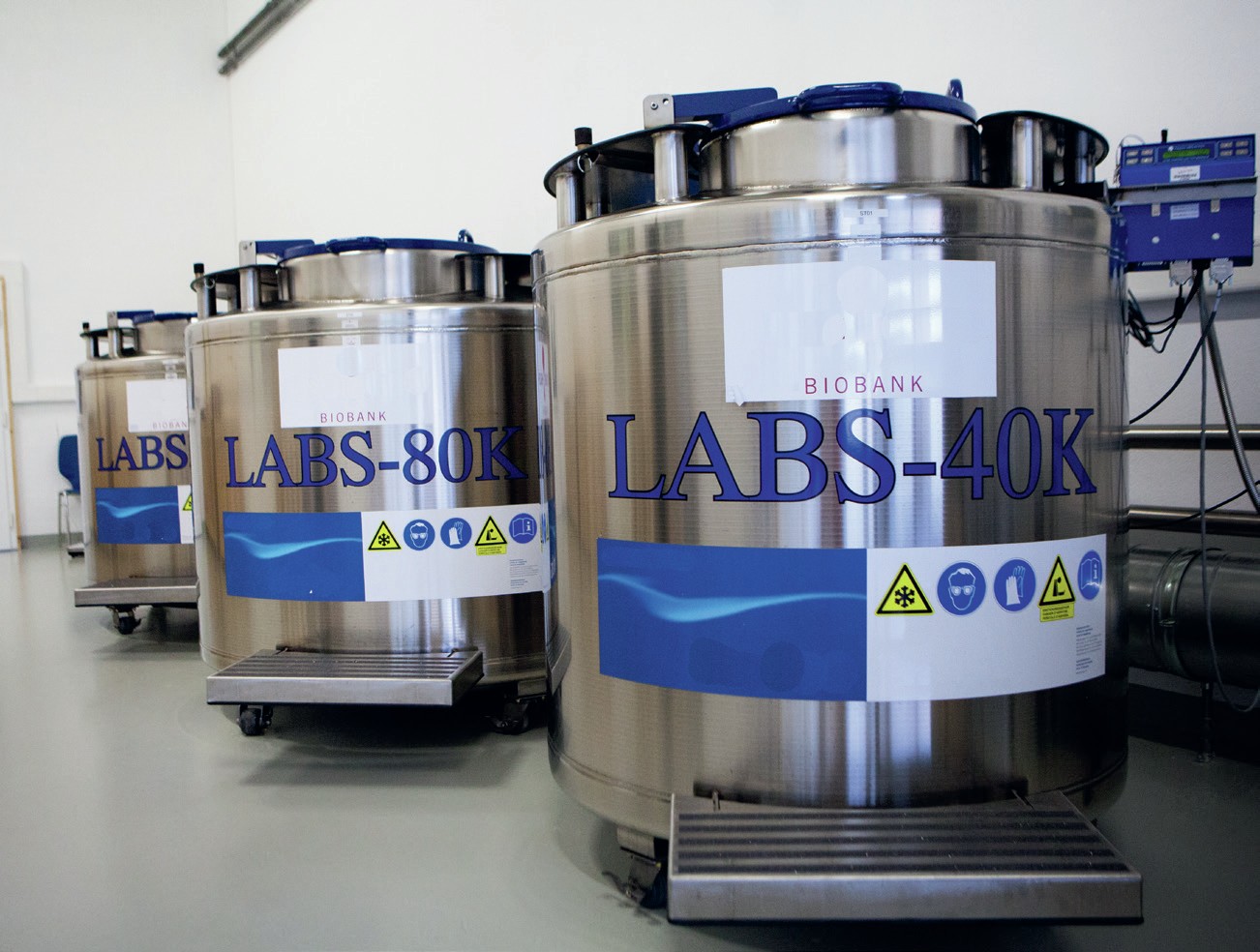 Three large metal tanks with ‘biobank’ written on them.