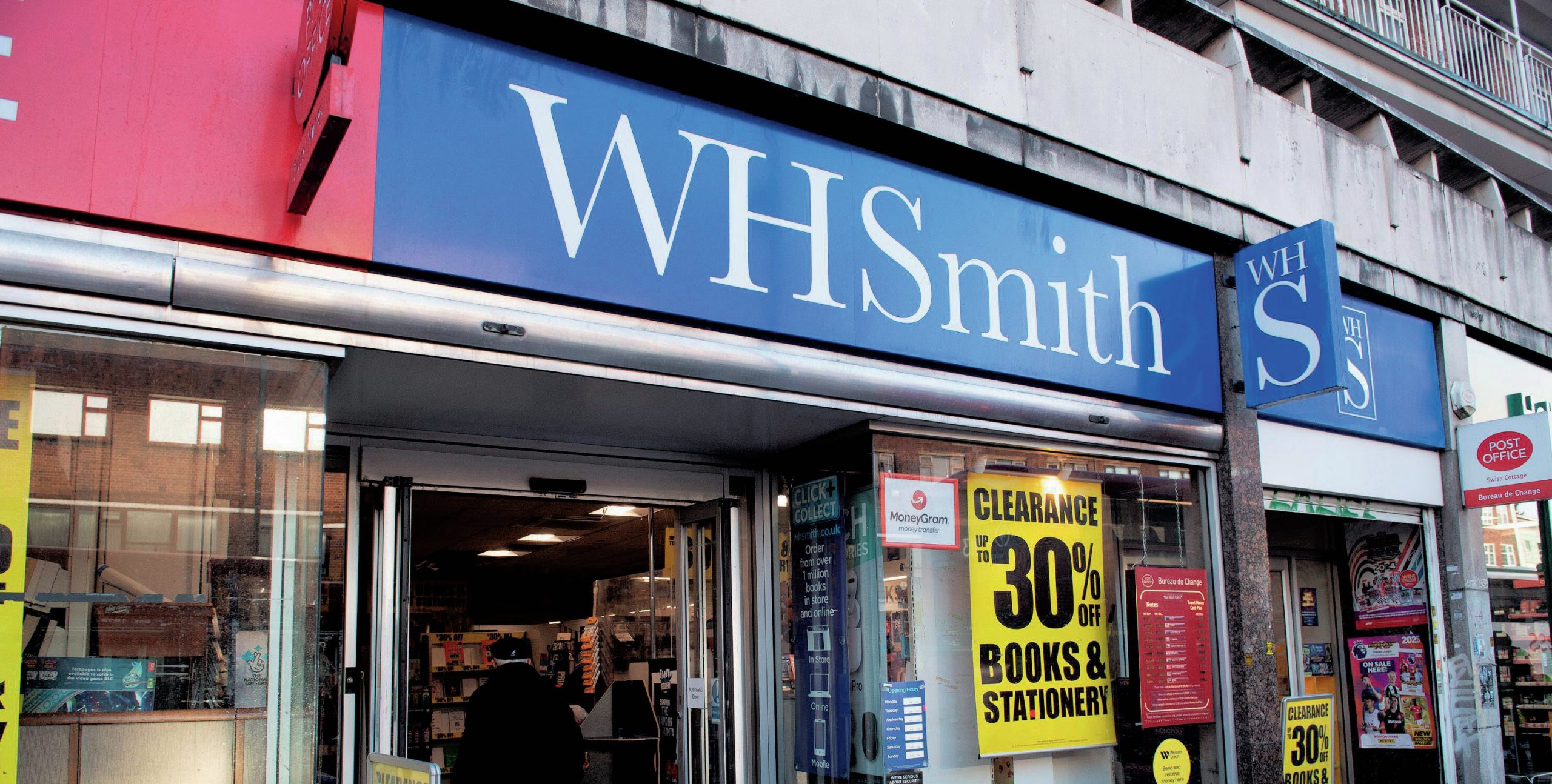 A WH Smith shop with a clearance sign in the window.