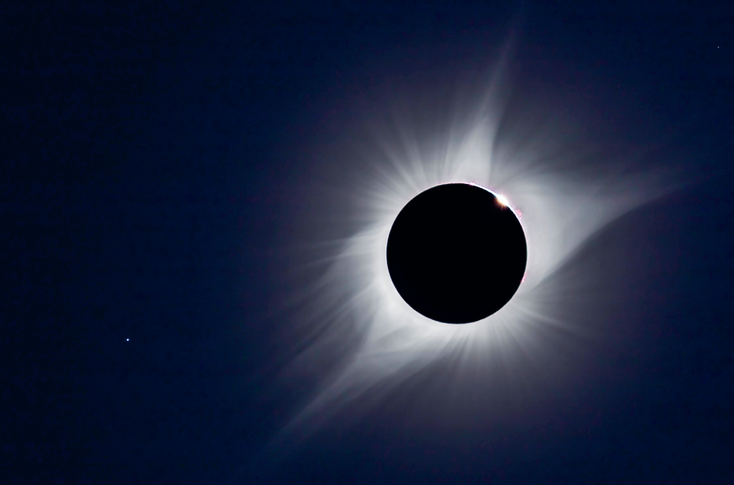 A black circle with white light around it.