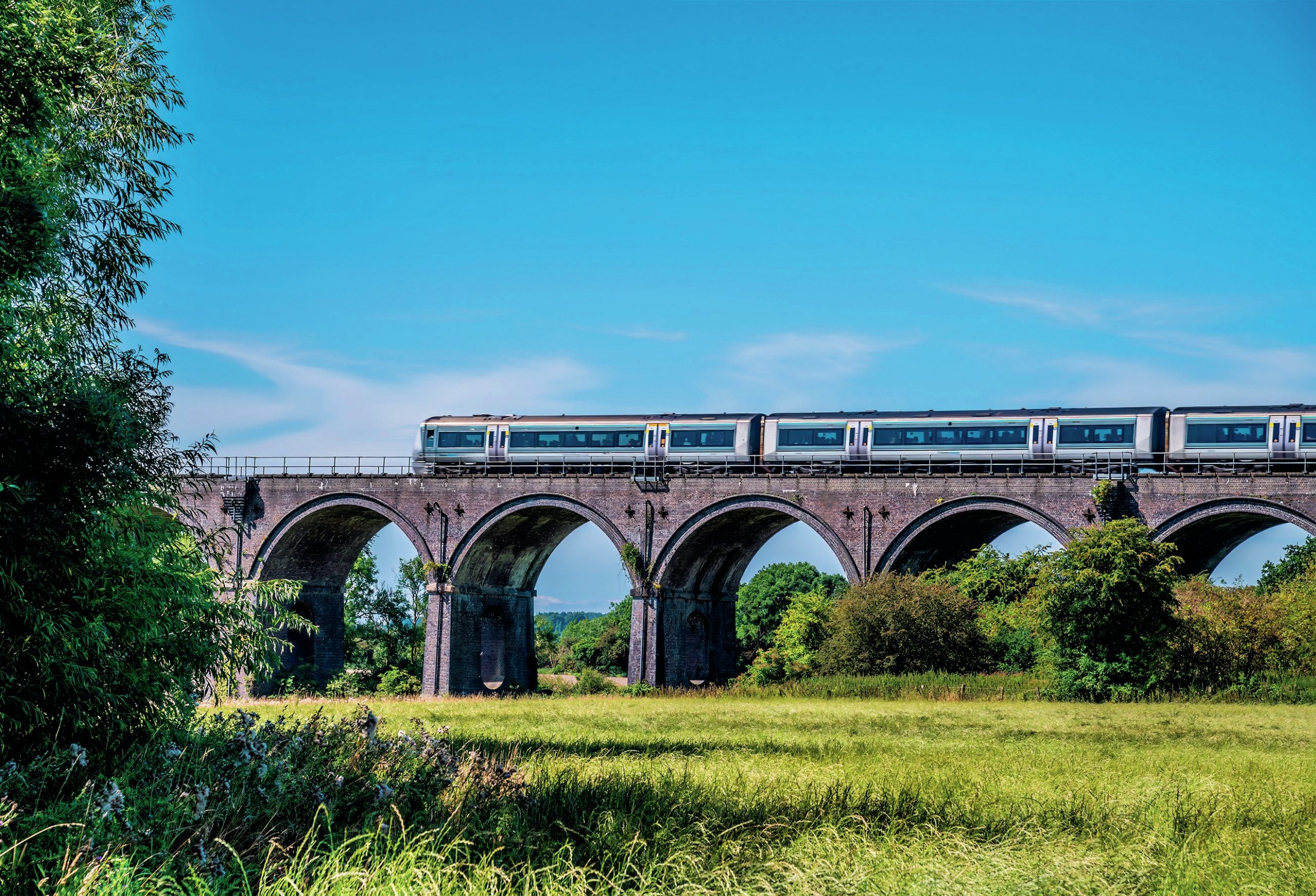 Train passes along a viaduct.