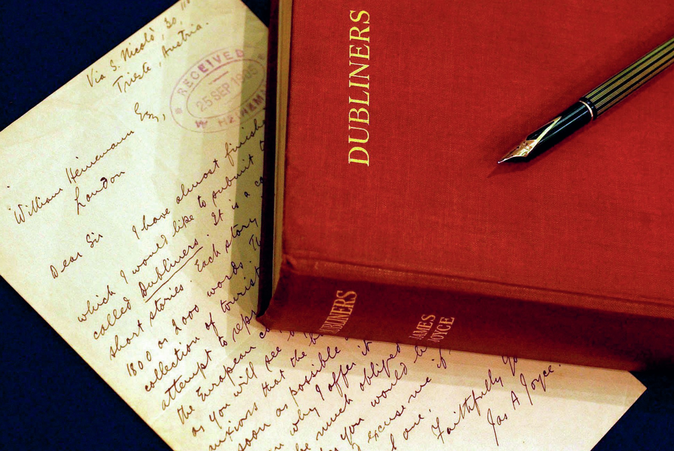 Handwritten letter, with a copy of the book of Dubliners on top of it.