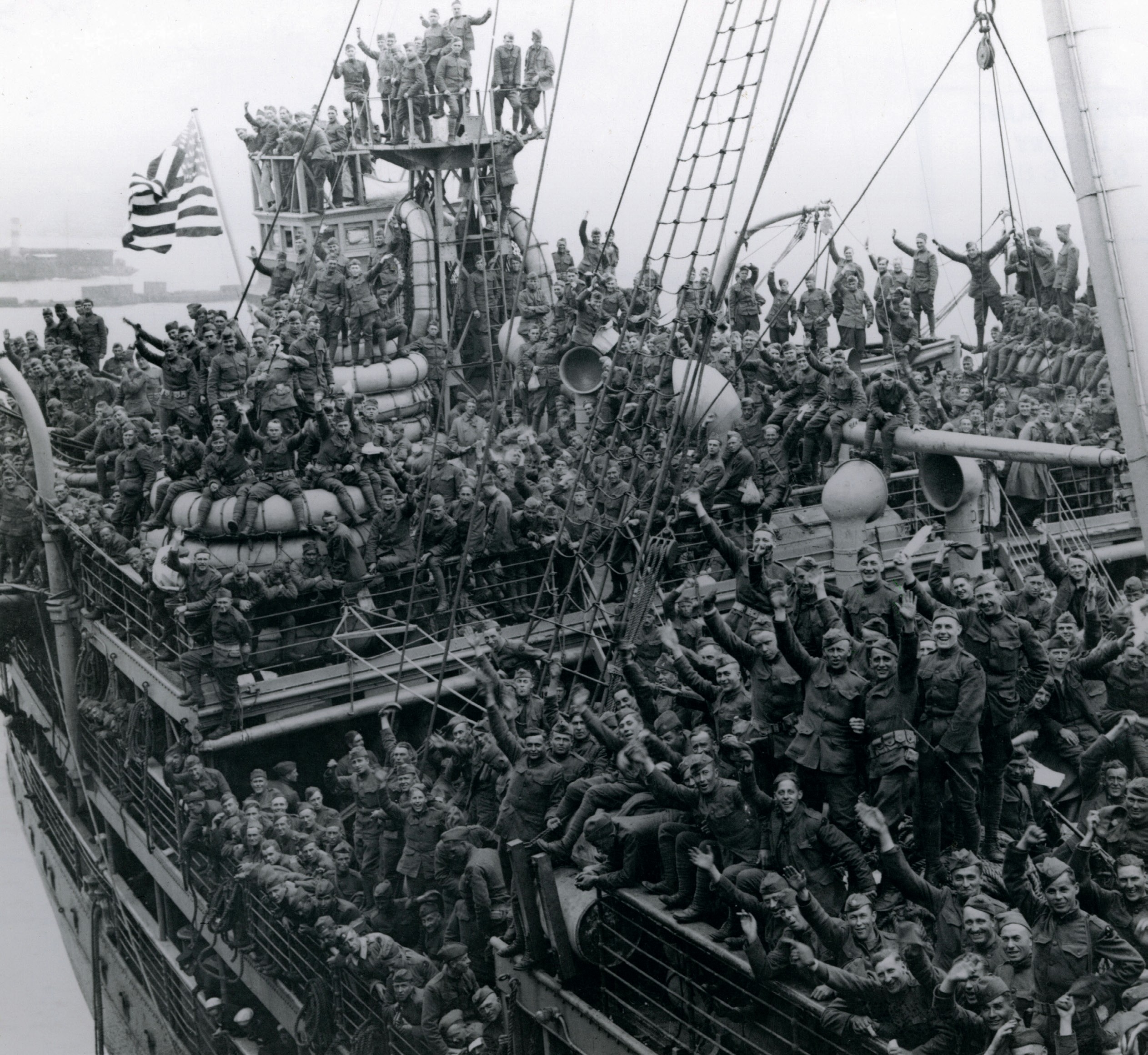 Ship arriving in the dock with hundreds of soldiers on board.