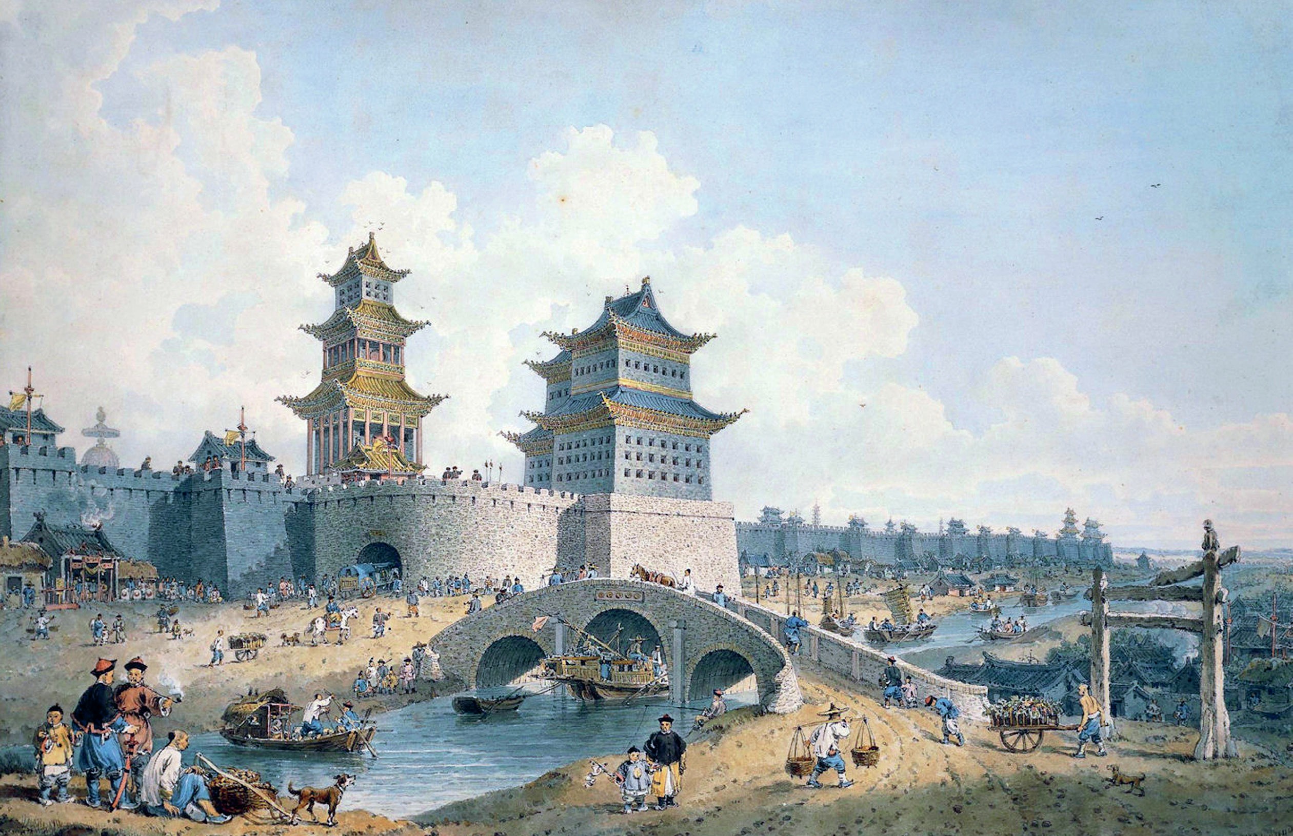 Bridge in front of town walls with elaborate buildings. People are walking over and beside the bridge.