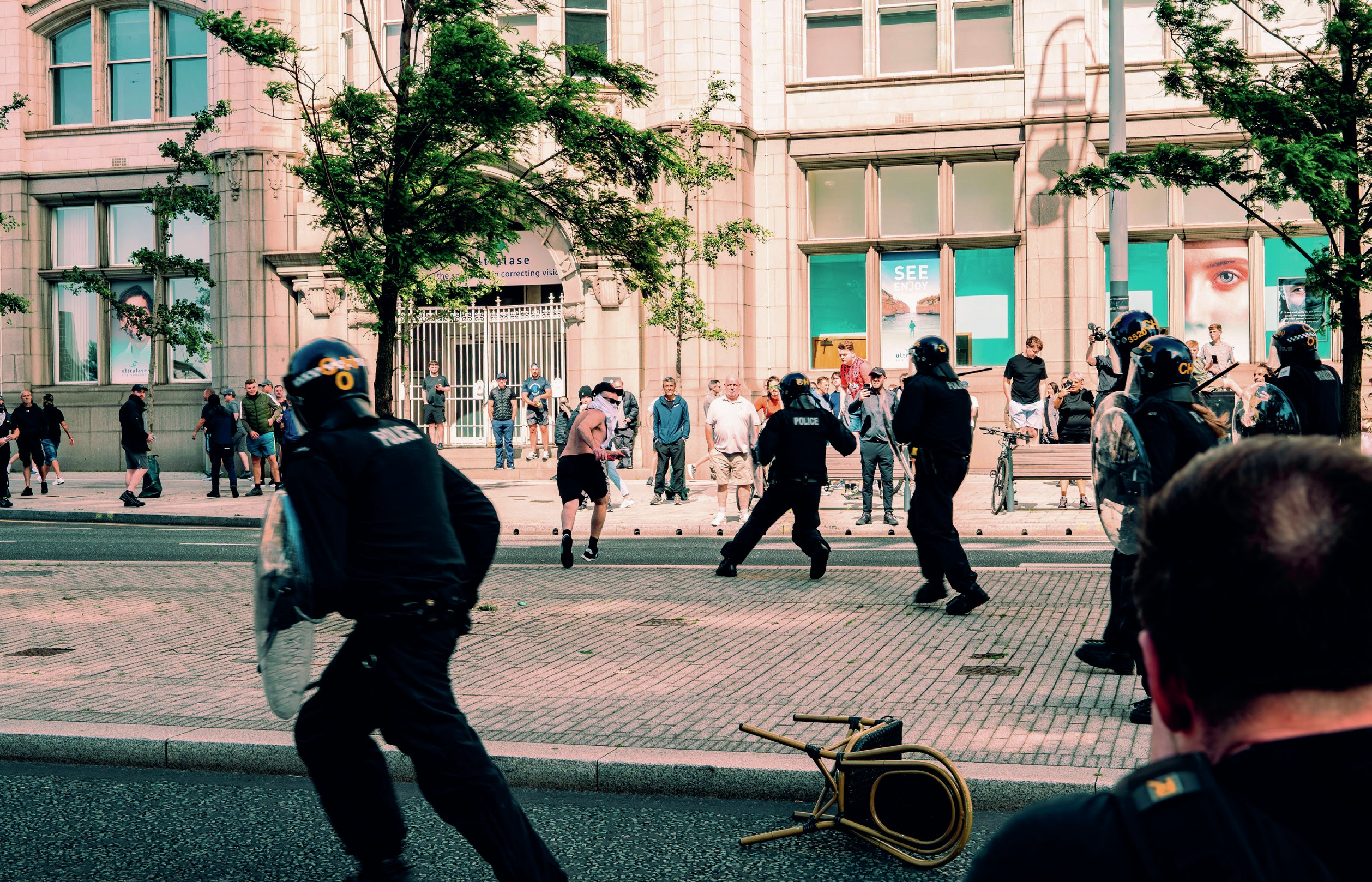 Street scene with police and rioters.