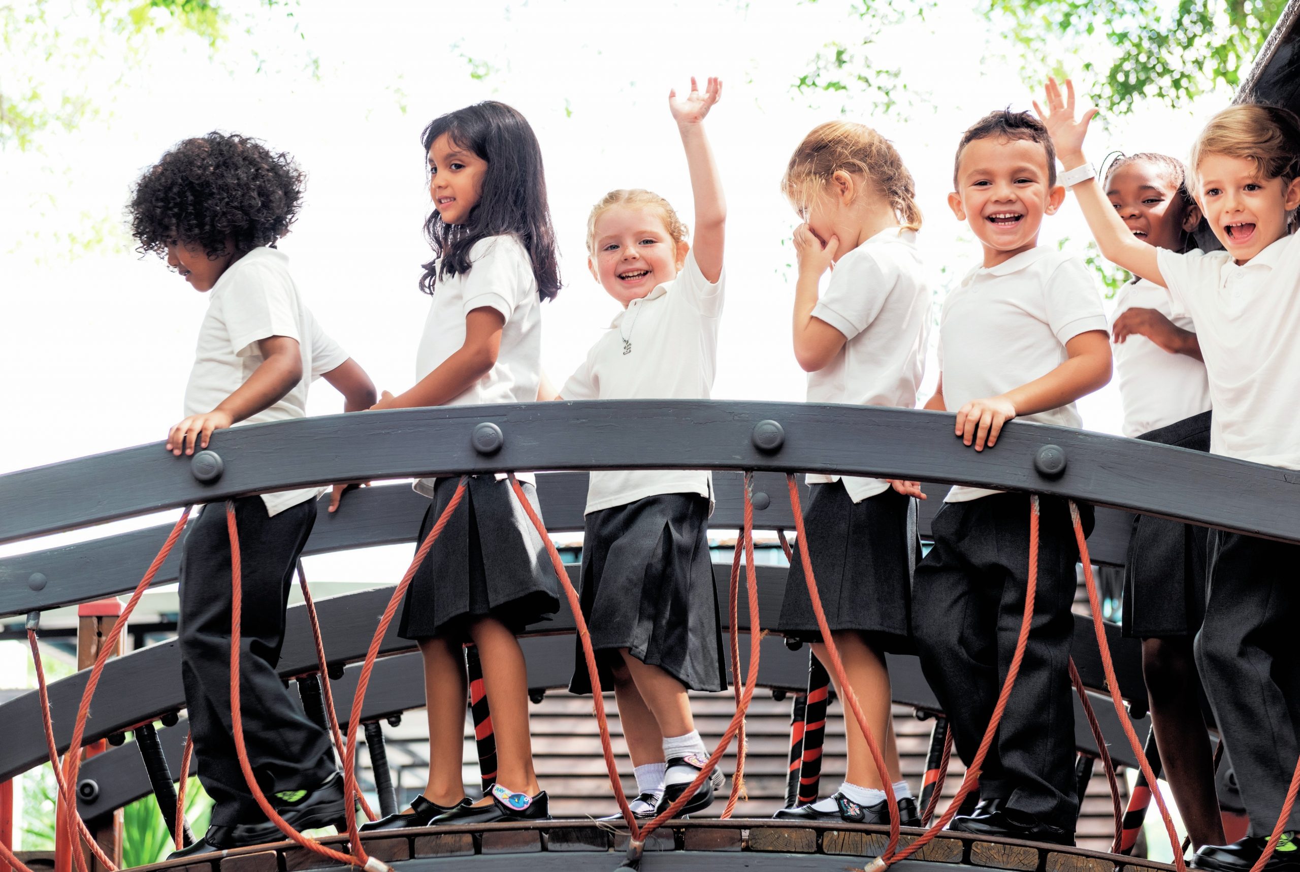 Group of children on a bridge.