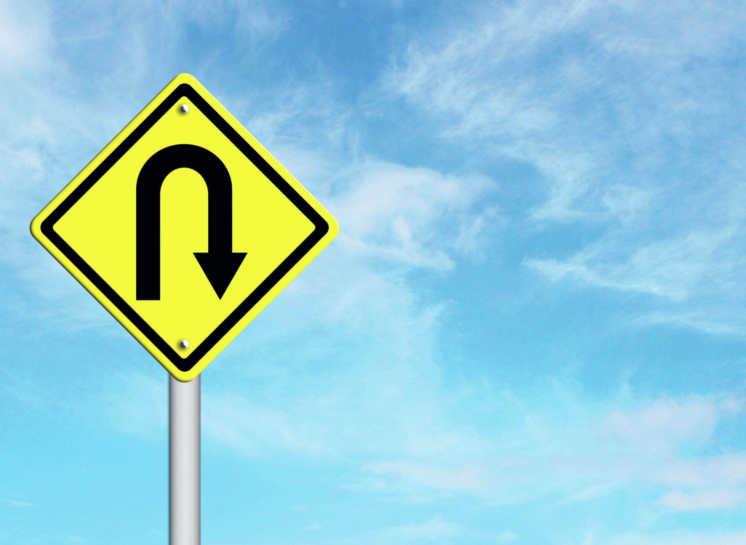 Road sign indicating a U-turn.