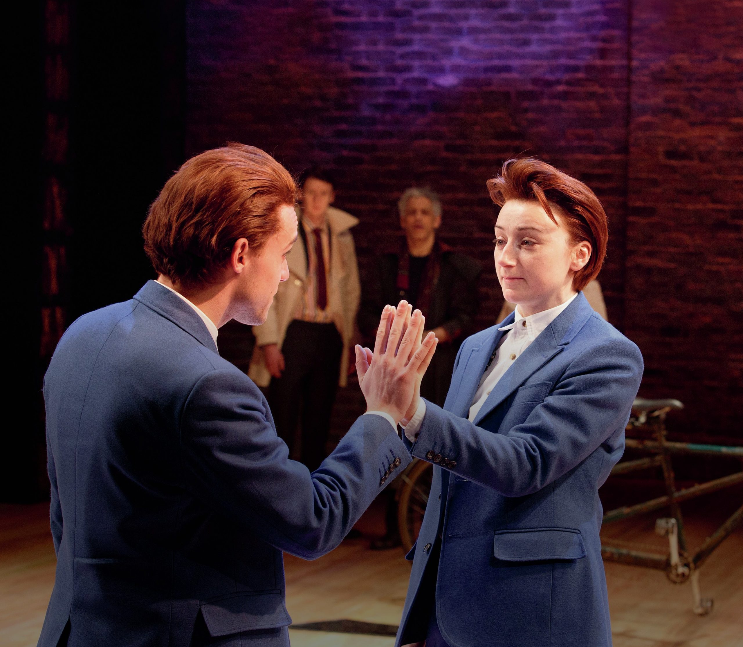 The two characters, are touching hands as if looking at a mirror.