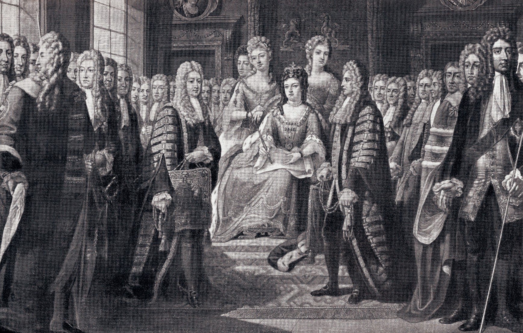 Queen Anne sits on a throne in the centre of a room holding some papers. There are three women behind her. She is surrounded by men wearing wigs.