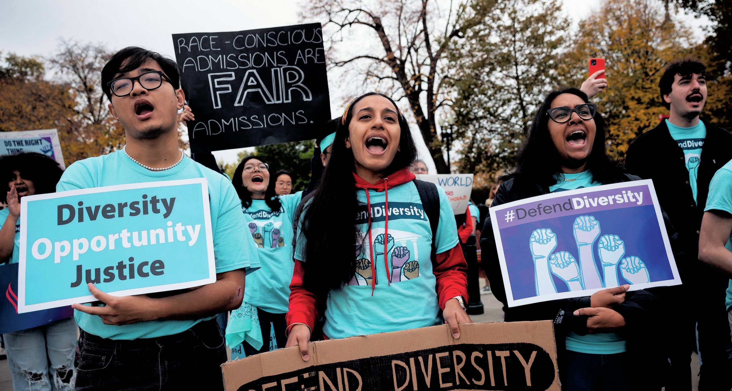 A group of students holding banners and shouting.