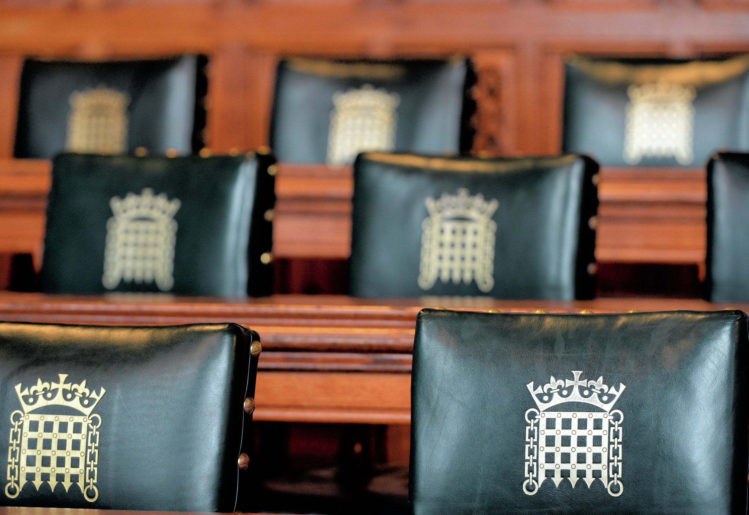 Green chairs with the House of Commons portcullis logo.