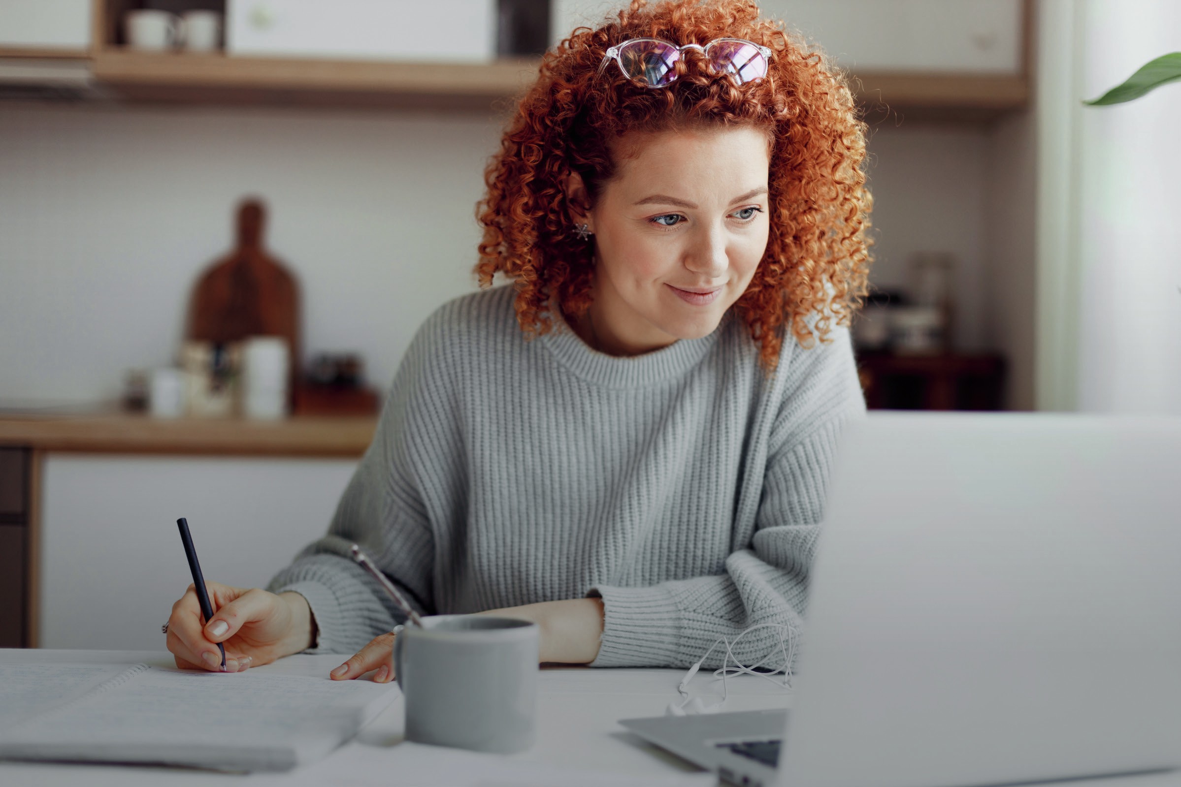 Female student looking pleased as she works.