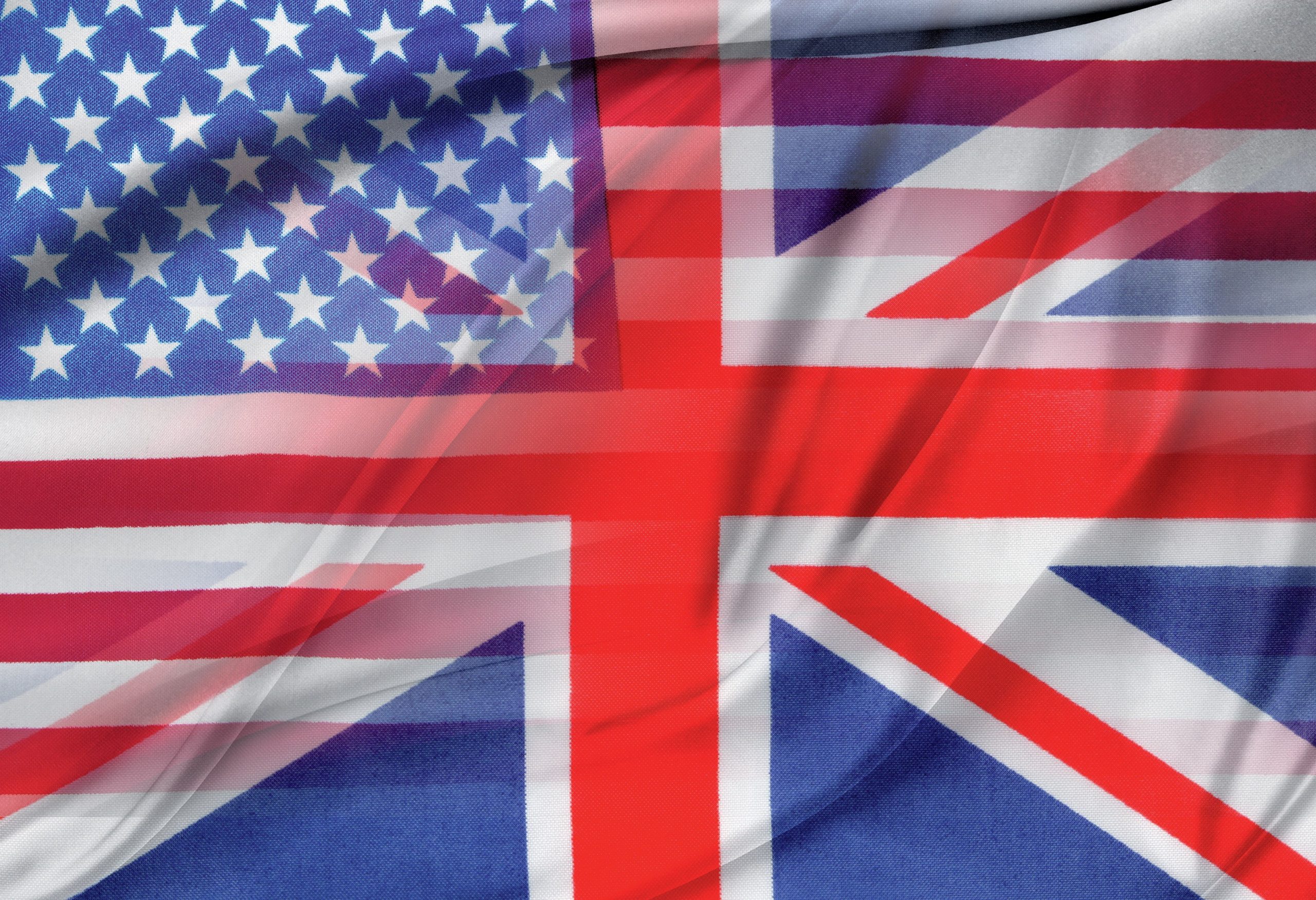 Blurred US and UK flags.