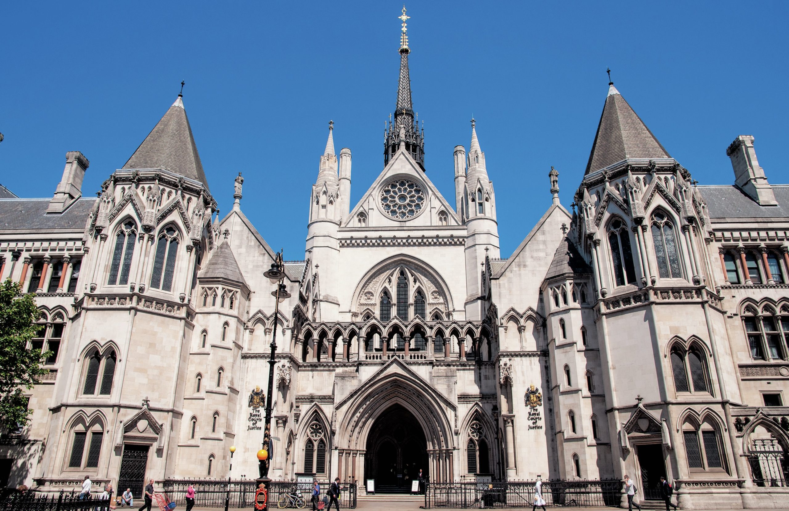The outside of the High Court with a blue sky above.